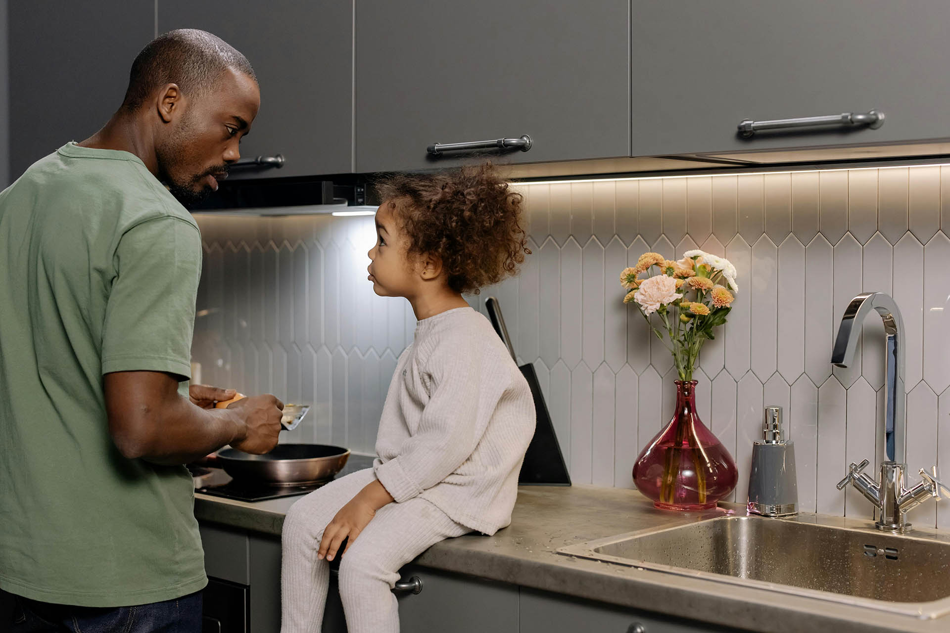 Family cooking together in modern apartment kitchen.
