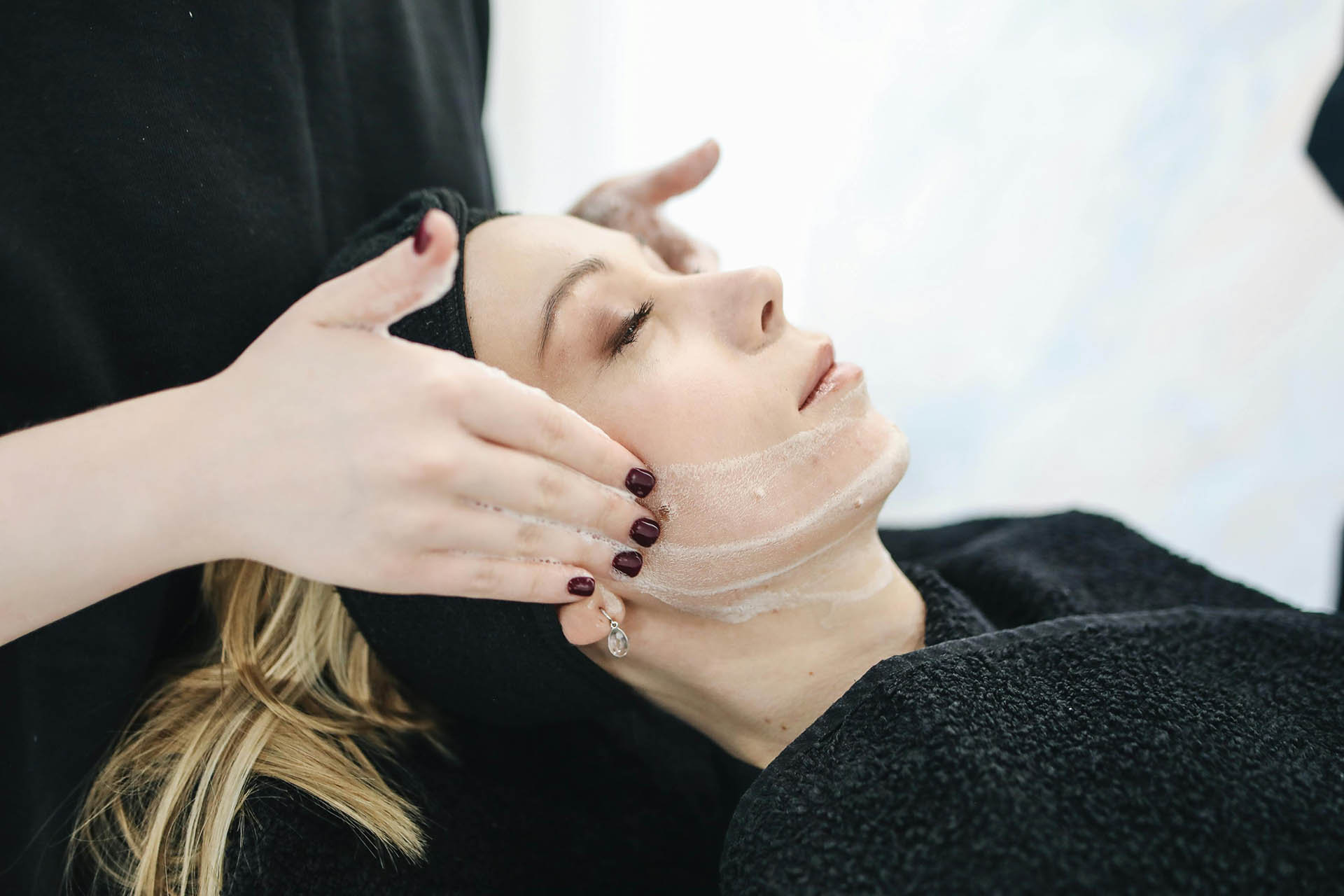 Person relaxing and receiving spa treatment.