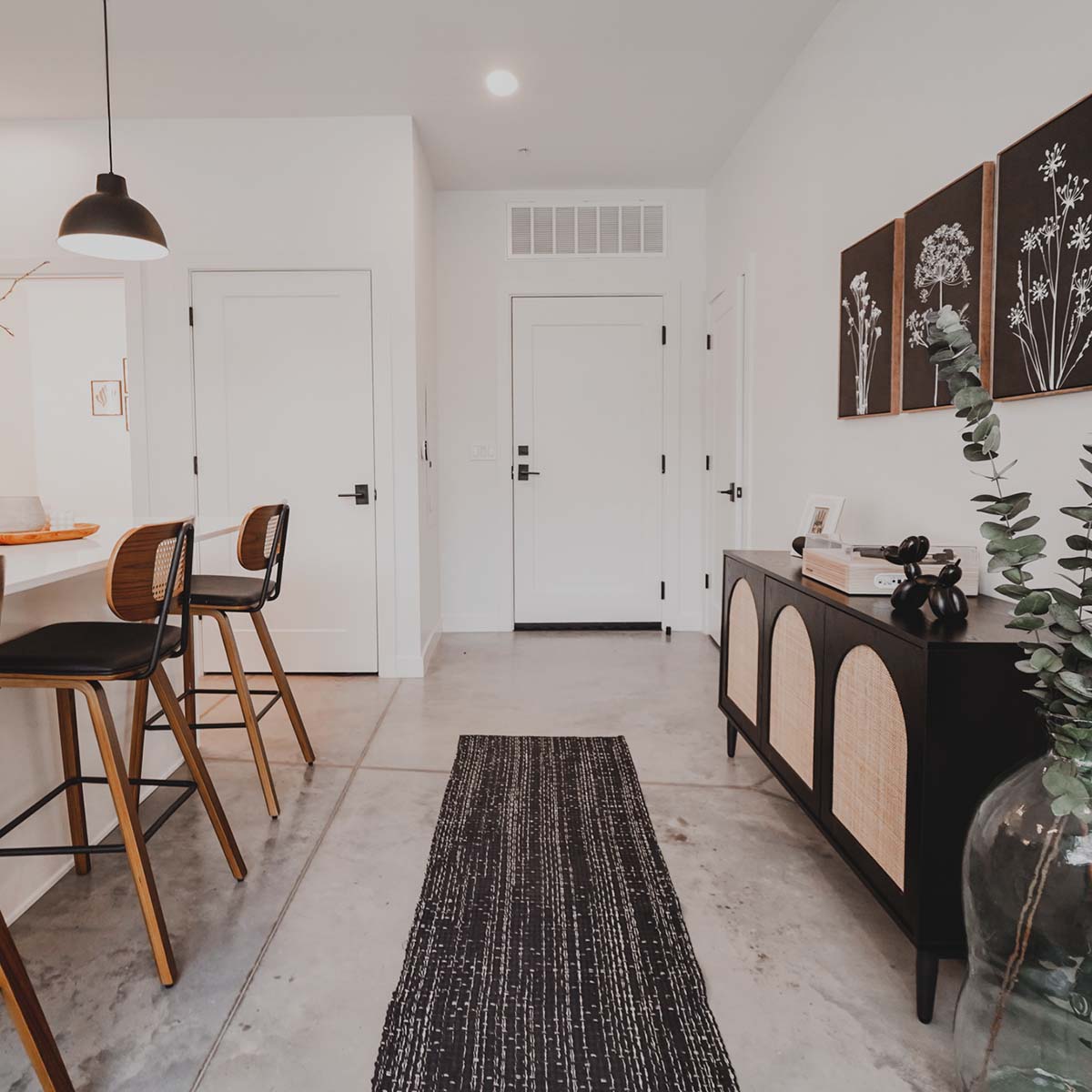 Entry way with kitchen on the left side and rug